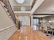 A grand two-story foyer features hardwood floors, a staircase with iron railings, and natural light at 3565 Hickory Branch Trl, Suwanee, GA 30024