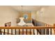 Open hallway with hardwood stairs, decorative light fixture, and neutral walls at 3565 Hickory Branch Trl, Suwanee, GA 30024