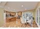 Open floor plan featuring stainless steel appliances, kitchen island, and adjacent dining area at 3565 Hickory Branch Trl, Suwanee, GA 30024