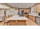 Spacious kitchen with island, stainless steel appliances, and adjacent living area with staircase at 3565 Hickory Branch Trl, Suwanee, GA 30024