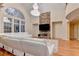 Spacious living room with stone fireplace, large windows, and elegant chandelier at 3565 Hickory Branch Trl, Suwanee, GA 30024