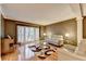 Cozy living room featuring hardwood floors, neutral paint, and large window with shutters at 3565 Hickory Branch Trl, Suwanee, GA 30024