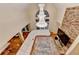 Living room features a stone fireplace, a chandelier, and a wall of windows, with plush sectional sofa at 3565 Hickory Branch Trl, Suwanee, GA 30024
