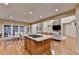 Open floor plan features kitchen island, dining area, and living room with stone fireplace at 3565 Hickory Branch Trl, Suwanee, GA 30024
