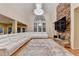 Spacious living room with vaulted ceilings, a stone fireplace, and a large window at 3565 Hickory Branch Trl, Suwanee, GA 30024