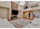 Bright living room showcasing a stone fireplace, balcony, and large area rug at 3565 Hickory Branch Trl, Suwanee, GA 30024
