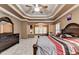 This is a main bedroom with decorative trey ceilings, dark wood furniture, and a connected sitting area at 3565 Hickory Branch Trl, Suwanee, GA 30024