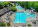 Aerial shot showcasing the community pool, kiddie pool, and slide surrounded by seating at 3565 Hickory Branch Trl, Suwanee, GA 30024