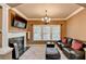This comfortable sitting room has a fireplace and large windows bringing in natural light at 3565 Hickory Branch Trl, Suwanee, GA 30024