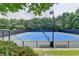 View of tennis court with blue surface and new net at 3565 Hickory Branch Trl, Suwanee, GA 30024