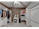 Spacious walk-in closet with custom shelving and a vanity area at 3565 Hickory Branch Trl, Suwanee, GA 30024