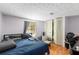 Bedroom featuring laminate floors and built-in closet doors at 4256 Village Square Ln, Stone Mountain, GA 30083