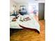 Bedroom with a large bed, dark wood floors, and a dresser at 4256 Village Square Ln, Stone Mountain, GA 30083