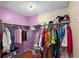 Walk-in closet with an organized clothing rack and shelving at 4256 Village Square Ln, Stone Mountain, GA 30083