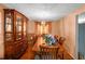 Elegant dining room featuring hardwood floors, ample seating, and a beautiful display cabinet at 4256 Village Square Ln, Stone Mountain, GA 30083