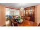 Charming dining room featuring hardwood floors, large table with seating, and vintage display cabinet at 4256 Village Square Ln, Stone Mountain, GA 30083