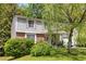 Inviting two-story home featuring an attached garage, mature landscaping, and an inviting front entrance at 4256 Village Square Ln, Stone Mountain, GA 30083