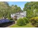 Inviting two-story home featuring an attached garage, mature landscaping, and a private driveway at 4256 Village Square Ln, Stone Mountain, GA 30083