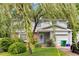 Charming two-story home with a well-maintained lawn, mature tree, attached garage, and lovely curb appeal at 4256 Village Square Ln, Stone Mountain, GA 30083