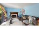 Cozy living room with a fireplace, light blue walls, and a sliding door for natural light at 4256 Village Square Ln, Stone Mountain, GA 30083