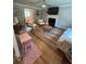 Bright living room with a fireplace, hardwood floors, and a large decorative clock at 190 Grayland Creek Dr, Lawrenceville, GA 30046