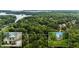 Beautiful aerial view of a house with an attached garage surrounded by lush trees and green space at 2709 Windrush Dr, Buford, GA 30518