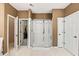 Bright bathroom featuring a glass shower and separate doors to closet and toilet spaces at 2709 Windrush Dr, Buford, GA 30518