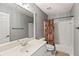 Gray-walled bathroom with a white sink vanity, toilet, shower, and modern mirror and fixtures at 2709 Windrush Dr, Buford, GA 30518