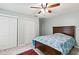 Cozy bedroom with ceiling fan, double closets, and a beautiful patterned quilt on the bed at 2709 Windrush Dr, Buford, GA 30518