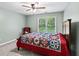 Cozy bedroom with soft natural light, a ceiling fan, and a colorful quilt on the bed at 2709 Windrush Dr, Buford, GA 30518