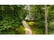 Long driveway leading to a charming home surrounded by lush trees at 2709 Windrush Dr, Buford, GA 30518