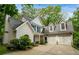 Charming two-story home featuring blue shutters, white siding, and an attached two car garage at 2709 Windrush Dr, Buford, GA 30518