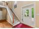 Bright foyer with hardwood floors, staircase, and a front door with sidelights at 2709 Windrush Dr, Buford, GA 30518