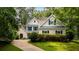 Charming two-story home featuring blue shutters, white siding, and a lush landscaped front yard at 2709 Windrush Dr, Buford, GA 30518