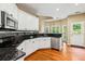 Well-lit kitchen with granite countertops, stainless appliances, tile backsplash, and access to the breakfast nook at 2709 Windrush Dr, Buford, GA 30518