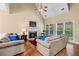 Bright living room featuring a fireplace, hardwood floors, and comfortable seating at 2709 Windrush Dr, Buford, GA 30518