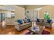 Open-concept living room with hardwood floors, high ceilings, and ample natural light at 2709 Windrush Dr, Buford, GA 30518