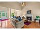 Open-concept living room with hardwood floors, high ceilings, and ample natural light at 2709 Windrush Dr, Buford, GA 30518