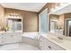 Spacious bathroom featuring double sinks, soaking tub, and separate shower at 2709 Windrush Dr, Buford, GA 30518