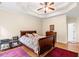 Cozy main bedroom featuring hardwood floors, tray ceiling, and lots of natural light at 2709 Windrush Dr, Buford, GA 30518