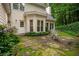 Charming backyard patio area surrounded by lush greenery and a view of the home at 2709 Windrush Dr, Buford, GA 30518