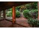 Serene backyard featuring mature trees, lush landscaping, and brick pillar at 3833 Savannah E Sq, Atlanta, GA 30340