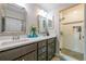 Bathroom featuring a walk-in shower, double sinks, and modern fixtures for a sleek design at 3833 Savannah E Sq, Atlanta, GA 30340