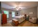 Cozy bedroom with a ceiling fan, neutral paint, carpet floors, and natural light from the windows at 3833 Savannah E Sq, Atlanta, GA 30340