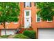Classic brick townhome with a private entrance, manicured landscaping, and attached garage at 3833 Savannah E Sq, Atlanta, GA 30340