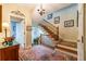 Bright foyer with staircase, chandelier, and hardwood floors at 3833 Savannah E Sq, Atlanta, GA 30340