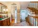 Entryway foyer featuring hardwood floors, staircase, and decorative mirror at 3833 Savannah E Sq, Atlanta, GA 30340