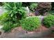 Lush garden featuring mature shrubs, flower beds, decorative accents and stone edging at 3833 Savannah E Sq, Atlanta, GA 30340