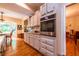 Spacious kitchen with stainless steel appliances, white cabinets, and hardwood flooring at 3833 Savannah E Sq, Atlanta, GA 30340