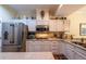 This kitchen has stainless steel appliances and white cabinets, providing ample storage at 3833 Savannah E Sq, Atlanta, GA 30340